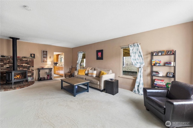 2824 Pacific Ave, Hoquiam, WA 98550 - living room featuring carpet floors, a textured ceiling, and a wood stove