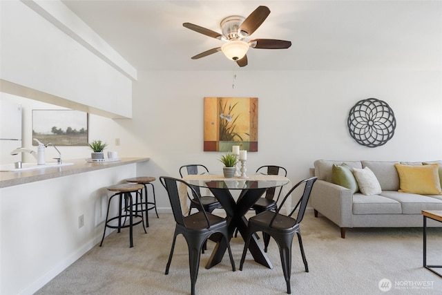130 NE 95th St Unit A203, Seattle, WA 98115 - dining area with a ceiling fan, baseboards, and light colored carpet