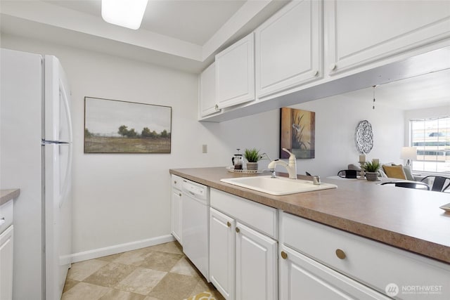 130 NE 95th St Unit A203, Seattle, WA 98115 - kitchen with baseboards, a sink, white cabinets, and white appliances