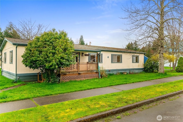 view of front facade featuring a front yard and a deck