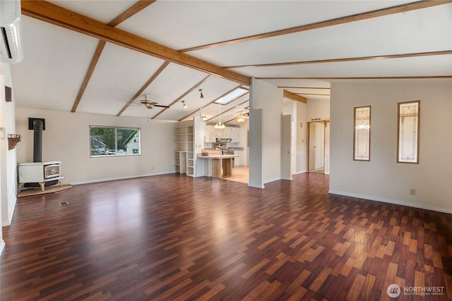unfurnished living room featuring baseboards, ceiling fan, wood finished floors, vaulted ceiling with beams, and an AC wall unit