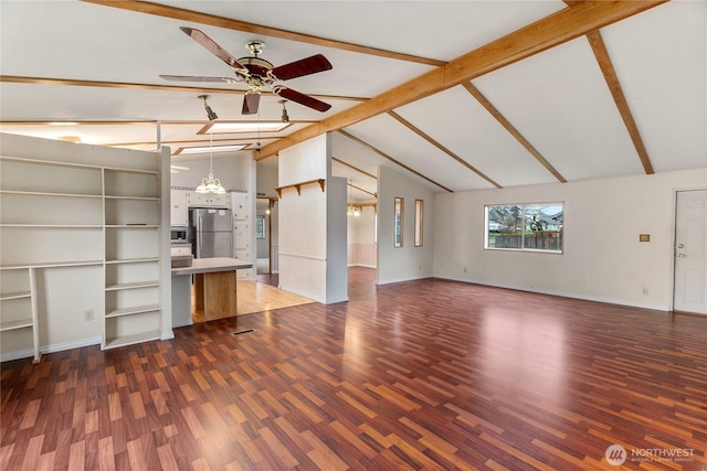 unfurnished living room featuring baseboards, lofted ceiling with beams, wood finished floors, and a ceiling fan