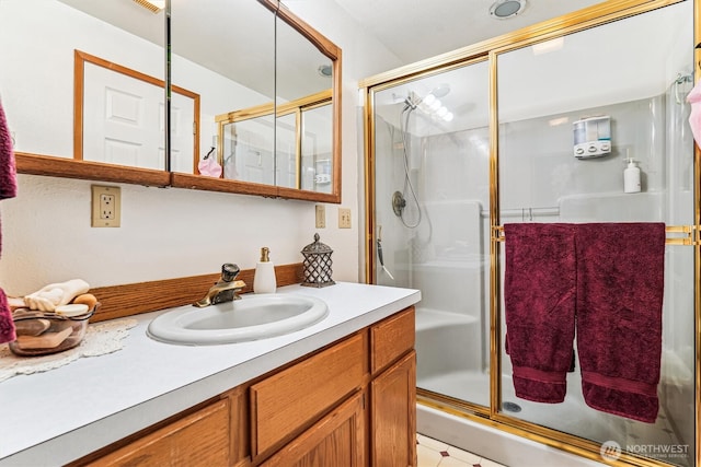 full bathroom with vanity and a shower stall
