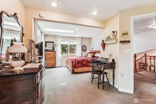 carpeted bedroom featuring beam ceiling, a skylight, and baseboards