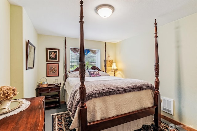 bedroom featuring baseboards and visible vents