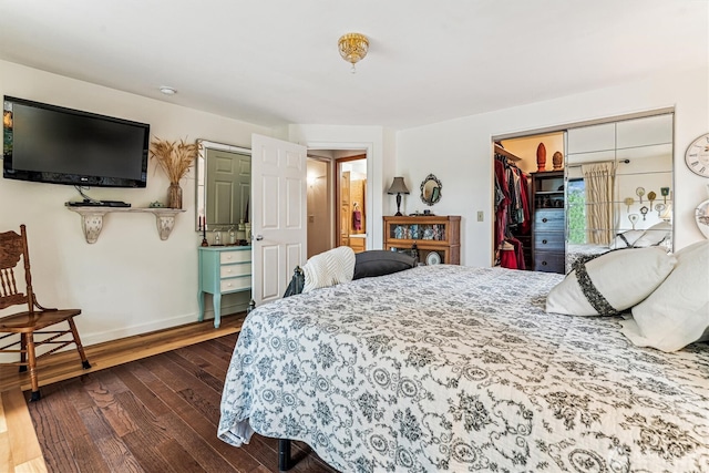 bedroom featuring baseboards and dark wood finished floors