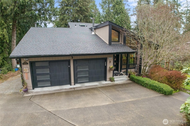 view of front of home featuring a shingled roof, a garage, and concrete driveway