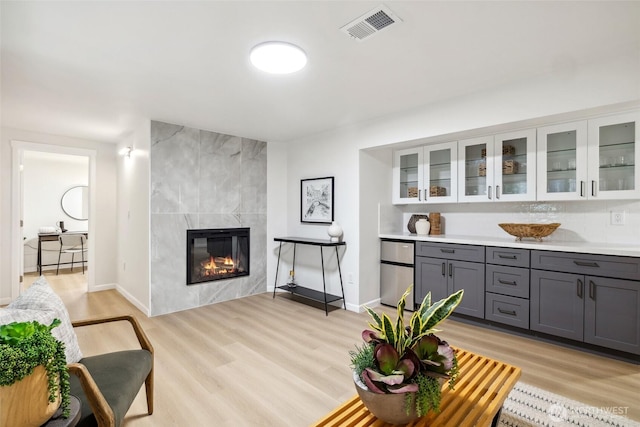 3115 103rd Ave NE, Bellevue, WA 98004 - living room with light wood-style flooring, a high end fireplace, and baseboards