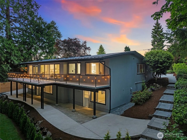 3115 103rd Ave NE, Bellevue, WA 98004 - back of property at dusk with a patio area