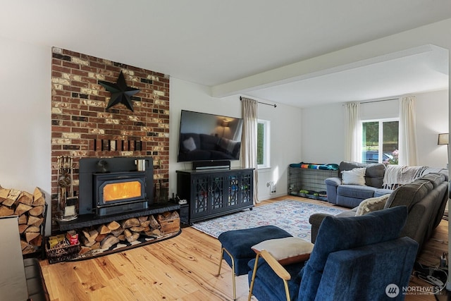 living area featuring beamed ceiling and wood finished floors