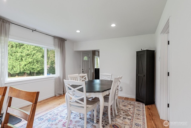 dining room with baseboards, recessed lighting, and light wood finished floors