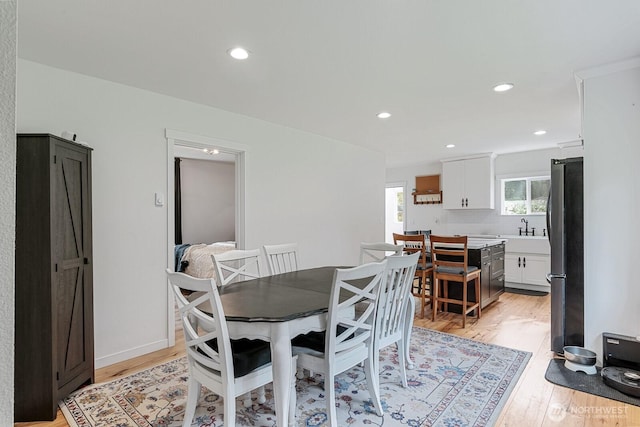 dining space featuring baseboards, recessed lighting, and light wood-type flooring