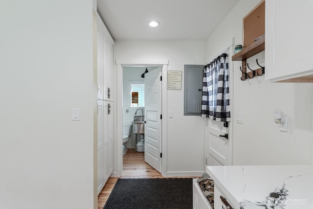 mudroom with light wood-style flooring and baseboards