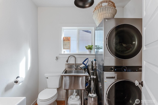 laundry room with stacked washer and clothes dryer and laundry area