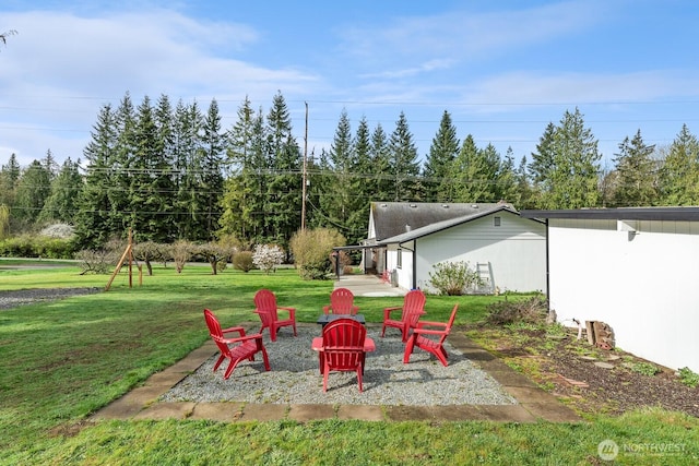 view of yard with a fire pit and a patio