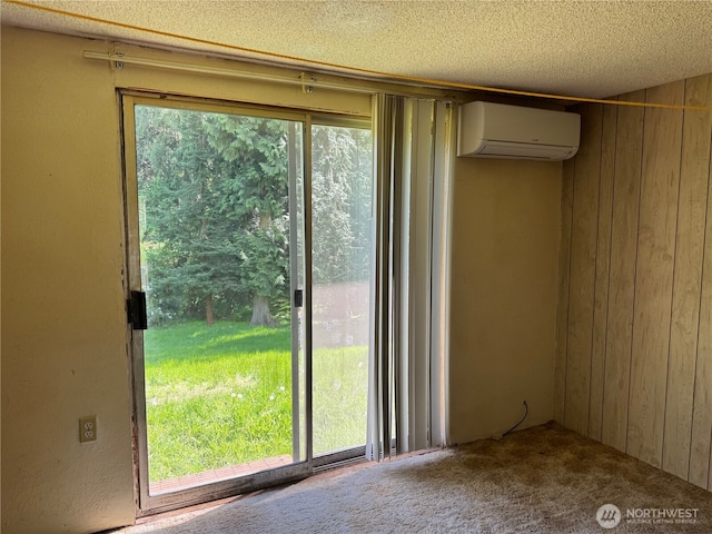 interior space with wooden walls, an AC wall unit, carpet floors, and a textured ceiling