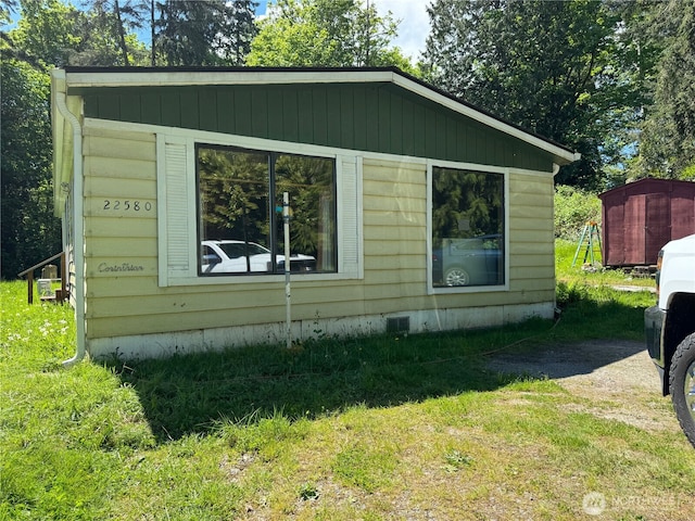 view of side of property with a lawn