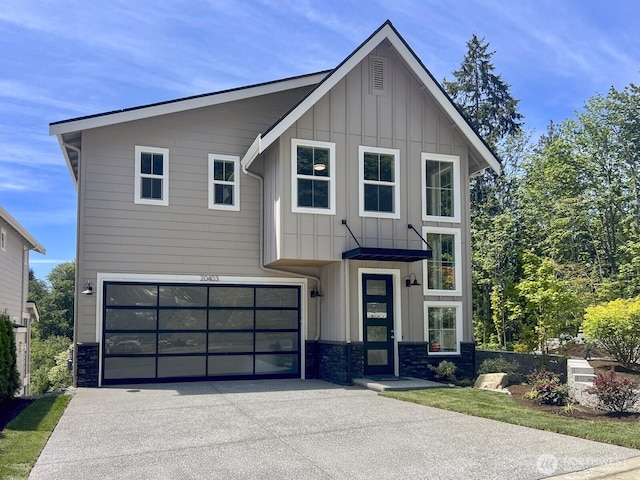 20317 94th Dr NE, Bothell, WA 98011 - modern home featuring board and batten siding, concrete driveway, stone siding, and a garage