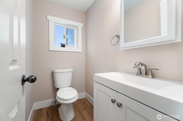 207 Harmon St, Waitsburg, WA 99361 - half bath featuring toilet, vanity, baseboards, and wood finished floors