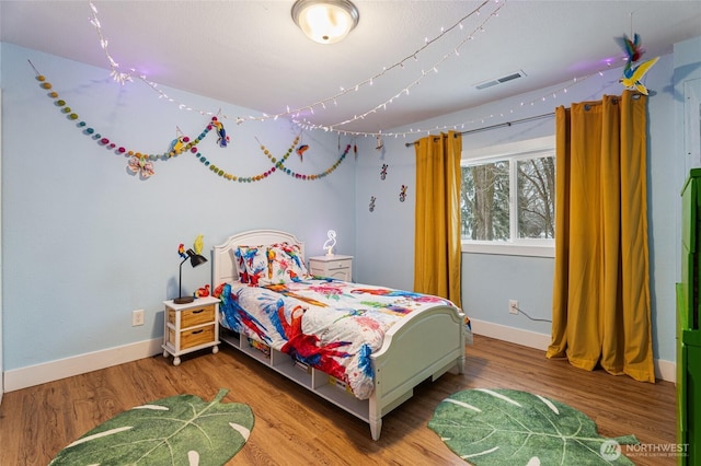 207 Harmon St, Waitsburg, WA 99361 - bedroom featuring baseboards, visible vents, and wood finished floors