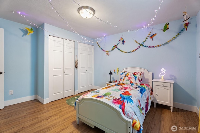 207 Harmon St, Waitsburg, WA 99361 - bedroom featuring two closets, baseboards, and wood finished floors