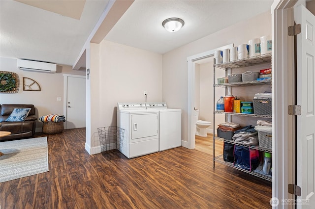 207 Harmon St, Waitsburg, WA 99361 - laundry area featuring wood finished floors, laundry area, baseboards, washer and dryer, and an AC wall unit