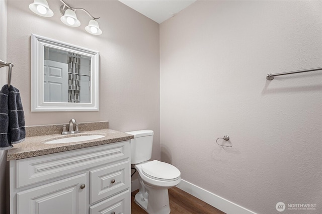 207 Harmon St, Waitsburg, WA 99361 - half bath with toilet, wood finished floors, baseboards, and vanity