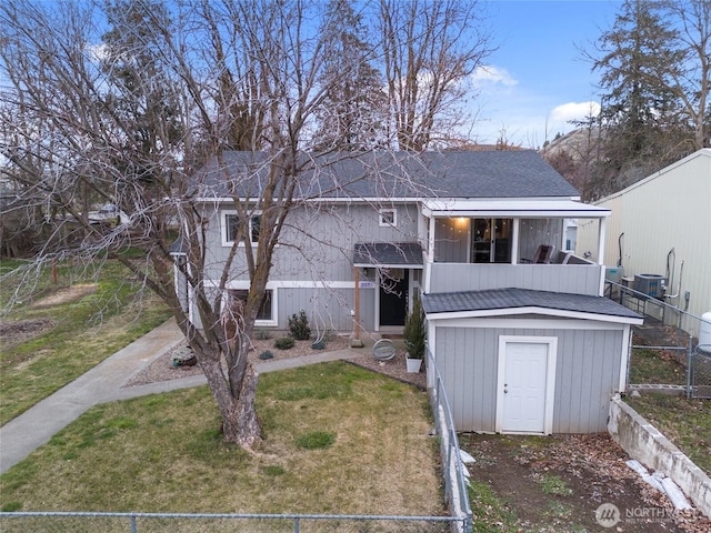 207 Harmon St, Waitsburg, WA 99361 - back of house featuring fence, cooling unit, roof with shingles, and a yard