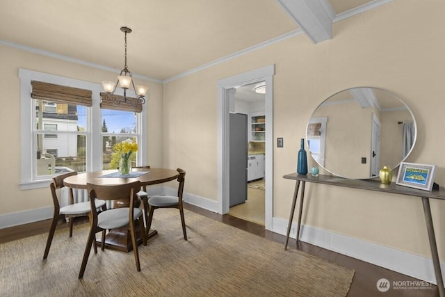 902 Wood Ave, Sumner, WA 98390 - dining area featuring a chandelier, baseboards, ornamental molding, and wood finished floors