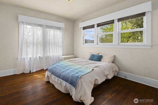 902 Wood Ave, Sumner, WA 98390 - bedroom featuring wood-type flooring, baseboards, and radiator
