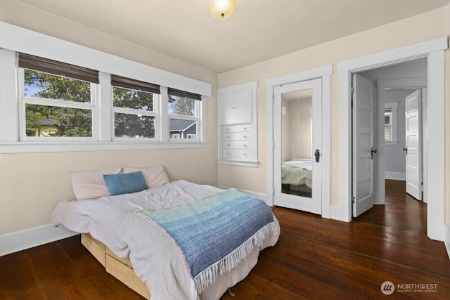 902 Wood Ave, Sumner, WA 98390 - bedroom with baseboards, multiple windows, and wood finished floors