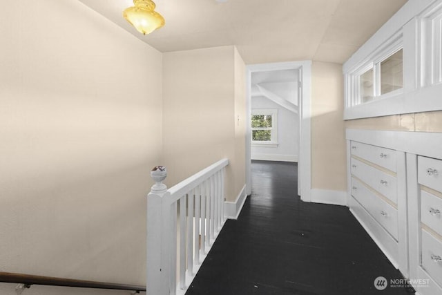 902 Wood Ave, Sumner, WA 98390 - hallway featuring an upstairs landing, dark wood-style floors, baseboards, and lofted ceiling