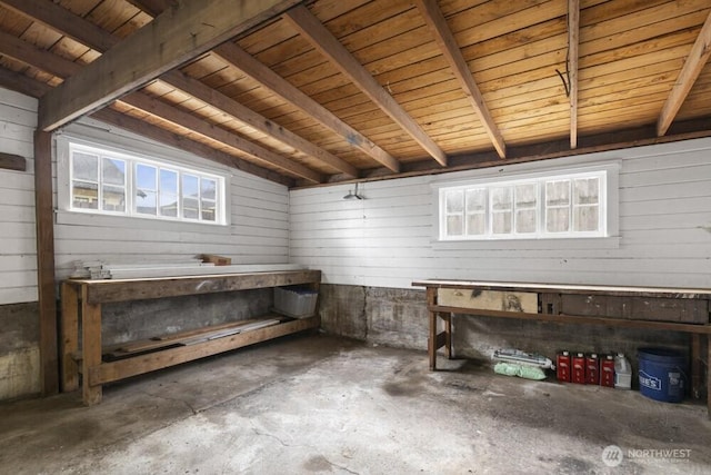 902 Wood Ave, Sumner, WA 98390 - miscellaneous room featuring a healthy amount of sunlight, unfinished concrete flooring, and a workshop area