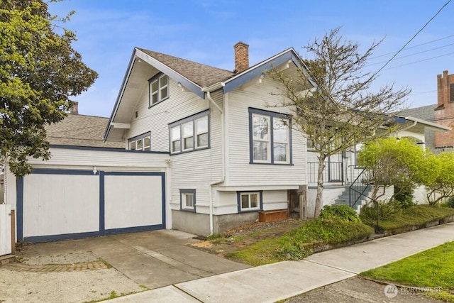 902 Wood Ave, Sumner, WA 98390 - view of front facade with roof with shingles, driveway, and a chimney