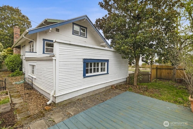 902 Wood Ave, Sumner, WA 98390 - view of side of property with a chimney, fence, and a deck