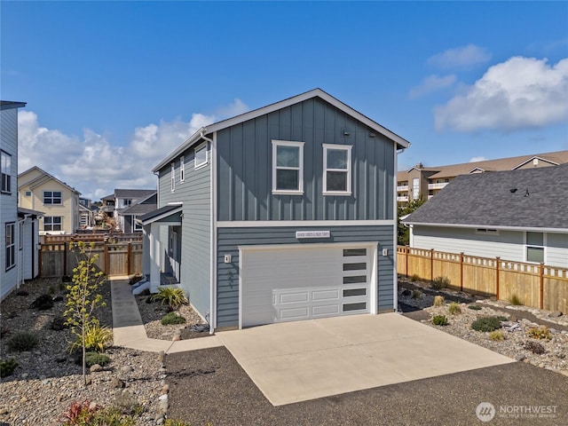 441 Lupine Ln SW, Ocean Shores, WA 98569 - view of front of home featuring fence, an attached garage, board and batten siding, a residential view, and driveway