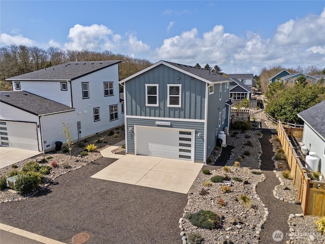 441 Lupine Ln SW, Ocean Shores, WA 98569 - view of front of home featuring fence, a garage, board and batten siding, a residential view, and driveway