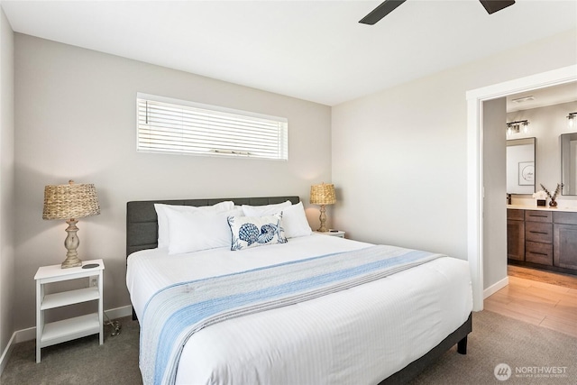 441 Lupine Ln SW, Ocean Shores, WA 98569 - bedroom featuring baseboards, ensuite bath, ceiling fan, and light colored carpet