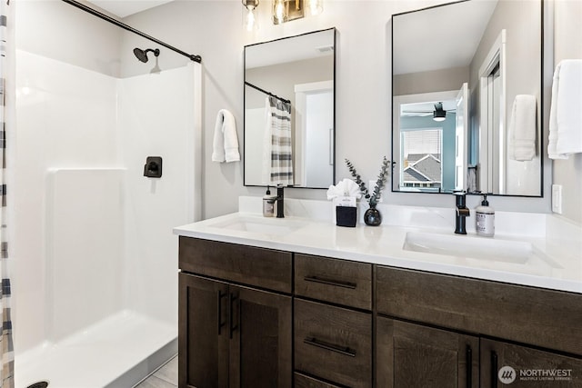 441 Lupine Ln SW, Ocean Shores, WA 98569 - full bath featuring a stall shower, double vanity, a sink, and a ceiling fan