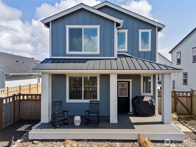441 Lupine Ln SW, Ocean Shores, WA 98569 - back of property with board and batten siding, a standing seam roof, fence, and metal roof