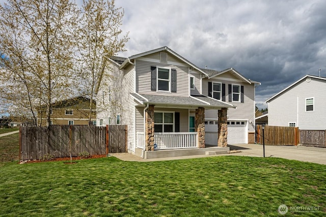 402 Easy St SE, Rainier, WA 98576 - traditional home with fence, a porch, a garage, and concrete driveway