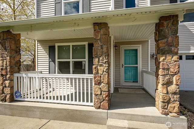 402 Easy St SE, Rainier, WA 98576 - entrance to property with stone siding, a garage, and a porch