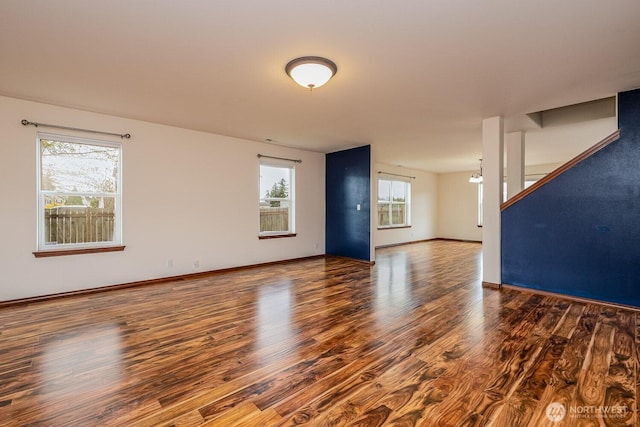 402 Easy St SE, Rainier, WA 98576 - unfurnished living room featuring baseboards and wood finished floors