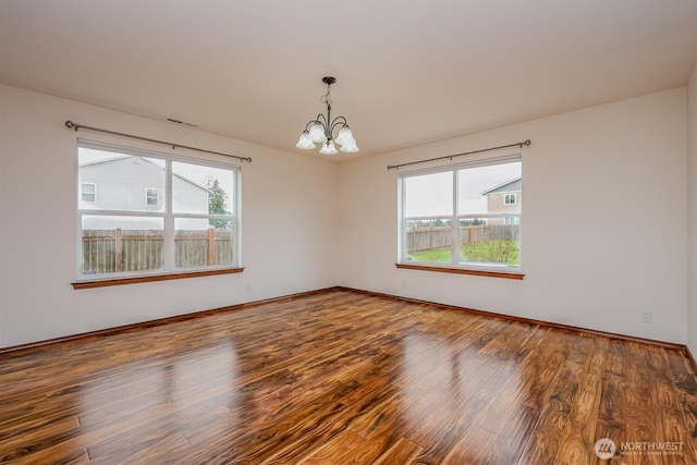 402 Easy St SE, Rainier, WA 98576 - spare room with a wealth of natural light, a notable chandelier, wood finished floors, and baseboards