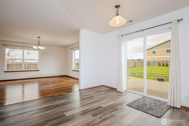 402 Easy St SE, Rainier, WA 98576 - interior space featuring baseboards, wood finished floors, and a notable chandelier