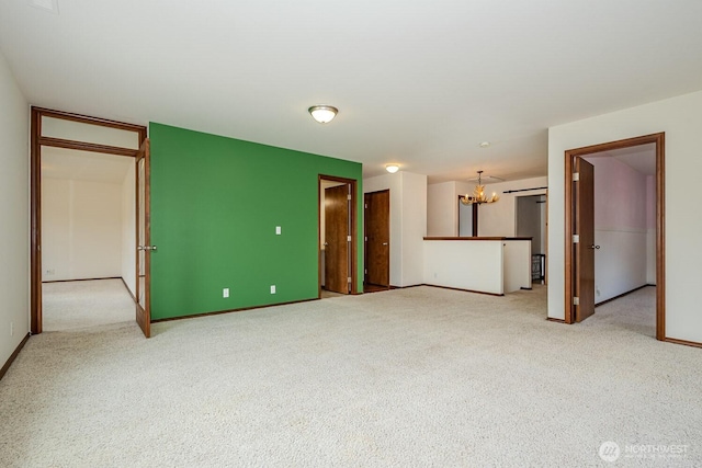 402 Easy St SE, Rainier, WA 98576 - spare room featuring baseboards, carpet floors, and a chandelier
