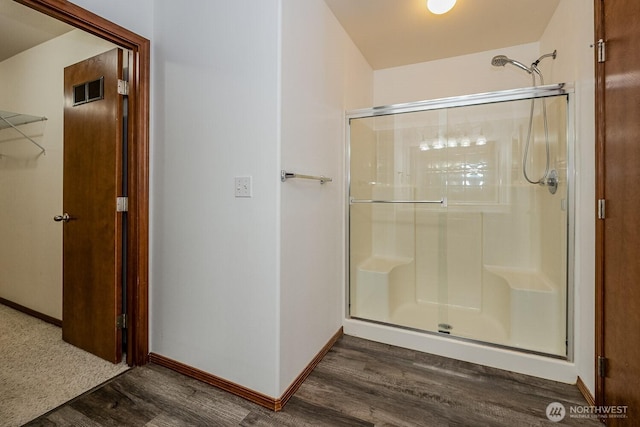402 Easy St SE, Rainier, WA 98576 - bathroom with visible vents, a stall shower, baseboards, and wood finished floors