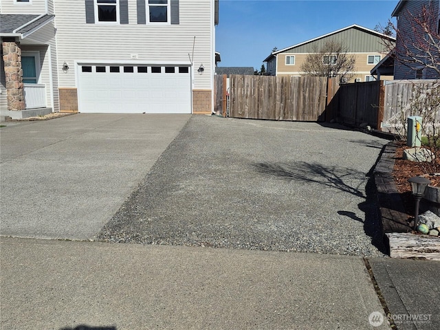 402 Easy St SE, Rainier, WA 98576 - exterior space with concrete driveway, fence, and an attached garage