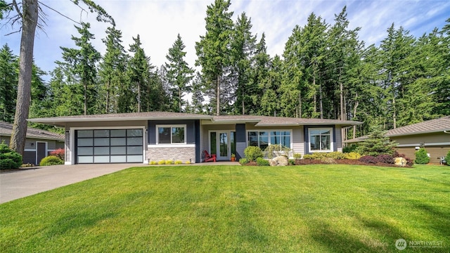 5469 Wood Duck Loop, Blaine, WA 98230 - view of front of house with a garage, concrete driveway, a front lawn, and stone siding