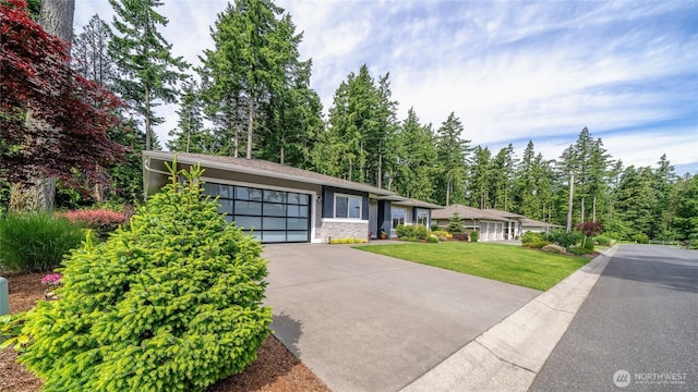 5469 Wood Duck Loop, Blaine, WA 98230 - view of front of house featuring concrete driveway, a front yard, stone siding, and a garage